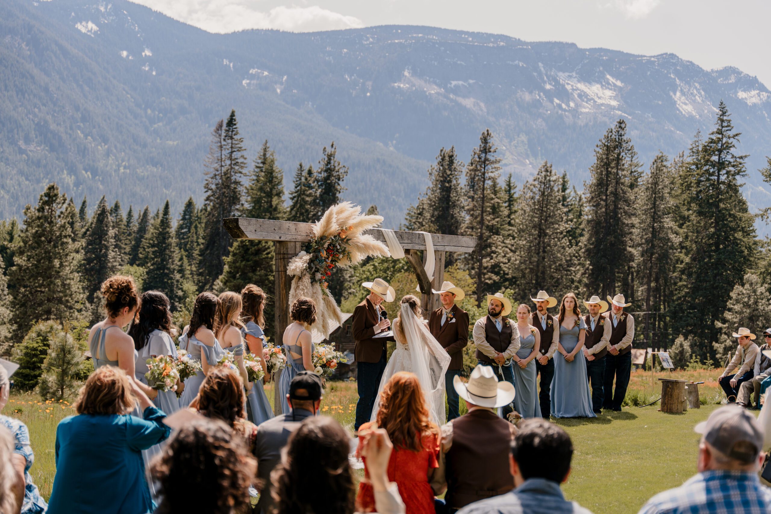 Washington wedding photographer capturing the mountain view during the wedding ceremony at Brown Family Homestead in Leavenworth, Washington