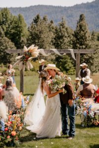 Washington wedding photographer capturing the first kiss at Brown Family Homestead in Leavenworth, Washington