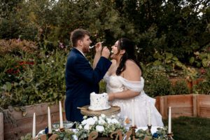 Washington wedding photographer documenting the couple eating cake during their wedding at The Barn on Hinman in Cashmere, Washington
