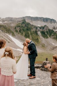 First kiss during elopement ceremony at Heather Meadows, Bagley Lakes