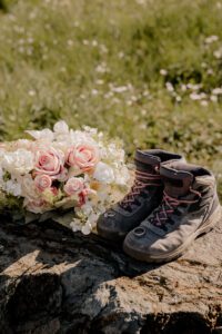 Mt Baker elopement details showcasing rings, bouquet, and hiking boots