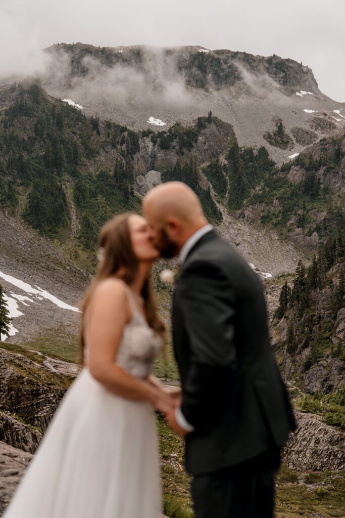 Eloping couple kissing at Heather Meadows in the Mt. Baker Wilderness.