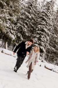A couple celebrates after getting engaged at Lake Wenatchee in Leavenworth, WA