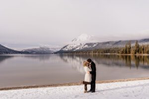 A couple celebrates after getting engaged at Lake Wenatchee in Leavenworth, WA