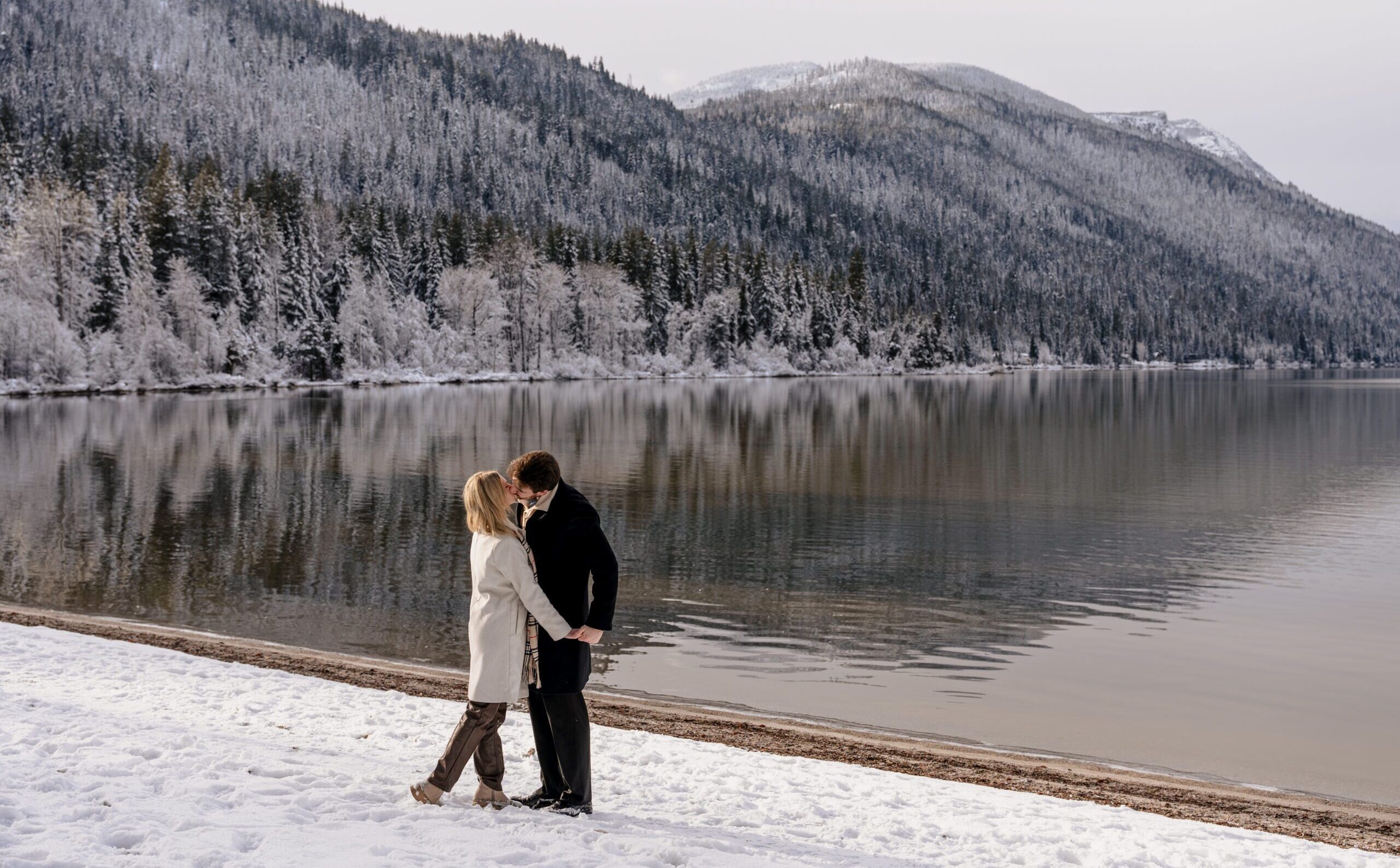 Newly engaged couple kissing at Lake Wenatchee in Leavenworth, Washington