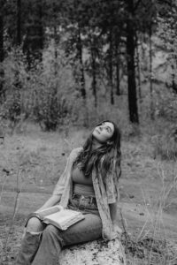 Senior portrait of a girl reading her Bible in the forest of Leavenworth, Washington