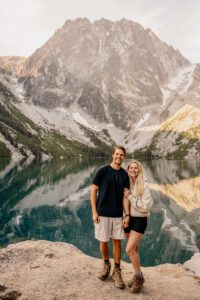 Couple taking engagement photos in front of Lake Colchuck