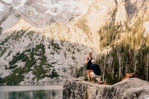 Man gets down on his knee to propose at Lake Colchuck in Leavenworth, Washington