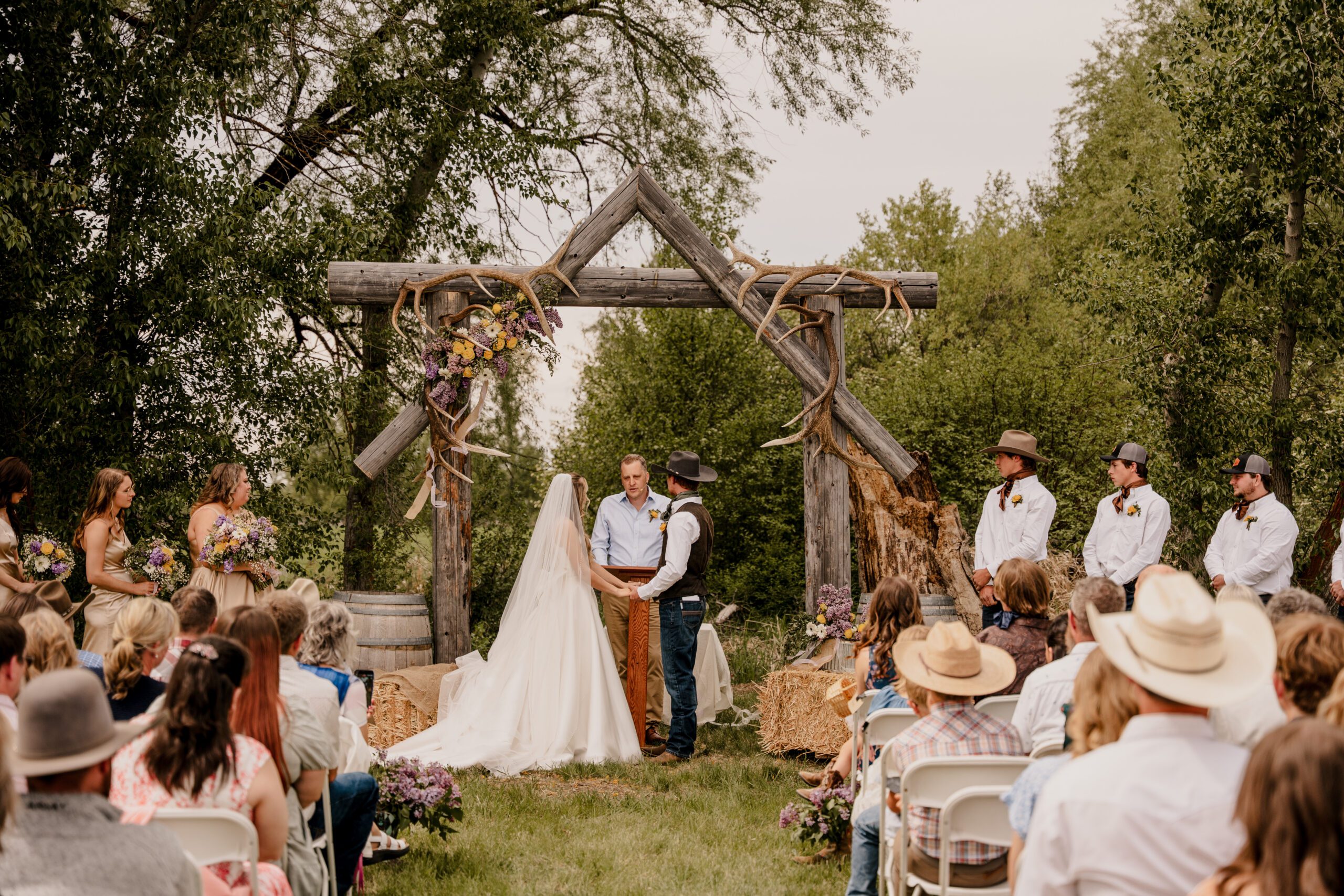 Rustic wedding ceremony with an arbor made of elk sheds in Ellensburg, Washington