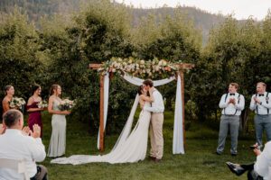 First kiss during the wedding ceremony at The Barn on Hinman