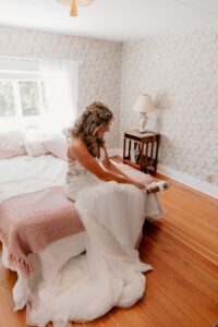 Bride butting on her wedding shoes at Brown Family Homestead