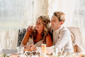Bride and groom listening to speeches at Brown Family Homestead