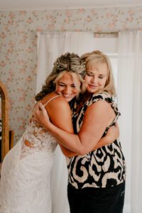 Bride and mom hugging while getting ready at Brown Family Homestead